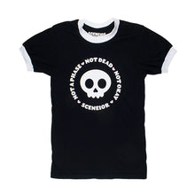 Load image into Gallery viewer, Black shirt with white trim around sleeves and collar. A skull sits in the middle with the phrase &quot;Not a phase, not dead, not okay&quot; surrounding it
